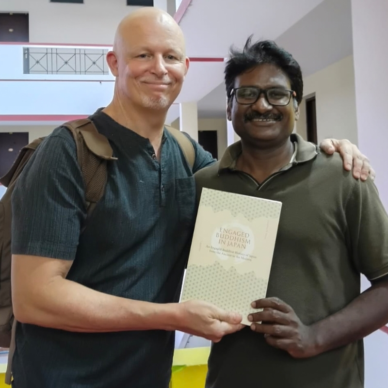 Jonathan S. Watts and Suriyakumar Ashoka holding Engaged Buddhism in Japan Volume One